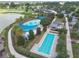 Aerial showcasing the community amenities including swimming pools, and a golf course by a scenic lake at 3918 Nw 46Th Ter, Ocala, FL 34482