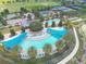 Aerial view of the resort-style pool area featuring expansive sun deck, palm trees, and inviting lounge chairs at 3918 Nw 46Th Ter, Ocala, FL 34482