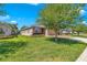 Well-manicured front yard featuring green grass and mature landscaping surrounding the charming single-story home at 3918 Nw 46Th Ter, Ocala, FL 34482