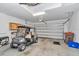 Spacious garage featuring an overhead door, lighting, storage, and a golf cart at 3918 Nw 46Th Ter, Ocala, FL 34482
