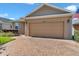 Exterior shot of the home featuring a two-car garage and brick paver driveway at 3918 Nw 46Th Ter, Ocala, FL 34482