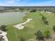 An aerial shot displays a lush golf course with a serene lake and sand traps surrounded by green landscape at 3918 Nw 46Th Ter, Ocala, FL 34482