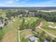 Scenic aerial view of the lush golf course, showcasing manicured greens, mature trees, and a tranquil pond at 3918 Nw 46Th Ter, Ocala, FL 34482