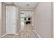 Hallway with wood floors offering a view of the open-concept living area and kitchen at 3918 Nw 46Th Ter, Ocala, FL 34482
