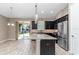 Open kitchen with stainless steel appliances, black cabinets and granite countertops at 3918 Nw 46Th Ter, Ocala, FL 34482