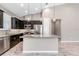 An open kitchen features a center island, stainless appliances, and granite counters at 3918 Nw 46Th Ter, Ocala, FL 34482