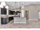 Modern kitchen with stainless steel appliances, granite countertops, and dark cabinetry at 3918 Nw 46Th Ter, Ocala, FL 34482