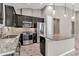 Modern kitchen with stainless steel appliances, granite countertops, and dark cabinetry with designer pendant lights at 3918 Nw 46Th Ter, Ocala, FL 34482