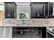 Kitchen with stainless steel appliances, tile backsplash and sink under window at 3918 Nw 46Th Ter, Ocala, FL 34482
