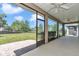 Screened patio with ceiling fans offers an open view of the backyard and landscaping at 3918 Nw 46Th Ter, Ocala, FL 34482
