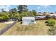 Private backyard featuring a detached garage with white siding and a neatly maintained lawn, great for storage at 4085 Sw 110Th St, Ocala, FL 34476