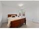 Cozy bedroom with natural light, carpeted floors, and a comfortable wood-framed bed at 4085 Sw 110Th St, Ocala, FL 34476