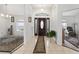 Spacious foyer with tile flooring, featuring a decorative rug leading to the main entrance door at 4085 Sw 110Th St, Ocala, FL 34476
