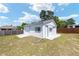 Detached two-car garage with white siding, blue trim, and concrete approach in a spacious yard at 4085 Sw 110Th St, Ocala, FL 34476