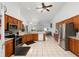 Spacious kitchen featuring stainless steel appliances, tile flooring, and wood cabinetry at 4085 Sw 110Th St, Ocala, FL 34476