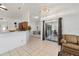 Open floor plan living room with breakfast bar, tile flooring, and sliding doors to a patio at 4085 Sw 110Th St, Ocala, FL 34476