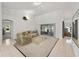 Bright living room with sliding glass doors, neutral tones, and comfortable seating arrangement at 4085 Sw 110Th St, Ocala, FL 34476