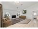 A living room with neutral walls, carpeting, and tile, featuring ample natural light and comfortable seating at 4085 Sw 110Th St, Ocala, FL 34476