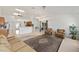 Living room featuring a tile floor, carpet, comfortable seating, and views into the kitchen at 4085 Sw 110Th St, Ocala, FL 34476