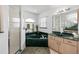 Main bathroom with tiled floors, double vanity sinks, soaking tub, and glass door shower at 4085 Sw 110Th St, Ocala, FL 34476