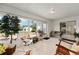 Comfortable sunroom with tile flooring, rocking chairs, and view of the exterior at 4085 Sw 110Th St, Ocala, FL 34476