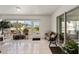 Inviting sunroom with tile flooring, bench seating, and an abundance of natural light at 4085 Sw 110Th St, Ocala, FL 34476
