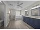 Bright bathroom featuring double vanities, gray cabinets, and tile flooring at 4401 Sw 44Th Ln, Ocala, FL 34474