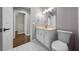 Bathroom featuring a white vanity, tan counter tops, and tile floors at 4401 Sw 44Th Ln, Ocala, FL 34474