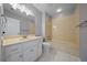 Bathroom with vanity, integrated sink, white cabinets, and a shower-tub combo at 4401 Sw 44Th Ln, Ocala, FL 34474