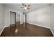 Large bedroom with hard wood floors, a ceiling fan, and a mirrored closet at 4401 Sw 44Th Ln, Ocala, FL 34474