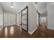 Entryway featuring modern sliding barn doors, hardwood floors, and contemporary lighting at 4401 Sw 44Th Ln, Ocala, FL 34474