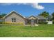 Charming single-story home featuring a stone facade, lush green lawn, and well-manicured landscaping at 4401 Sw 44Th Ln, Ocala, FL 34474