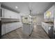 Bright kitchen with stainless steel appliances, granite countertops, and white cabinetry at 4401 Sw 44Th Ln, Ocala, FL 34474