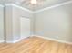 An empty bedroom includes wood floors and bi-fold closet doors at 4763 Se 25Th Loop, Ocala, FL 34480