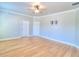 Spacious bedroom with wood floors, ceiling fan, and pre-installed TV mount at 4763 Se 25Th Loop, Ocala, FL 34480