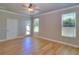 Inviting bedroom features wood floors, two windows, ceiling fan, and backyard access at 4763 Se 25Th Loop, Ocala, FL 34480