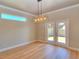 Bright dining room features wood floors, modern light fixture, and sliding glass doors leading to the backyard at 4763 Se 25Th Loop, Ocala, FL 34480