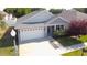 View of the home's exterior elevation showing the garage, front entrance, and landscaping at 4763 Se 25Th Loop, Ocala, FL 34480