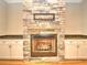 Living room fireplace boasts stone surround, wooden mantle, granite countertops, and built-in cabinets at 4763 Se 25Th Loop, Ocala, FL 34480