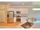 Beautiful kitchen with stainless steel appliances, white cabinetry, and granite countertops at 4763 Se 25Th Loop, Ocala, FL 34480