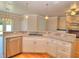 Open kitchen with stainless steel dishwasher, white cabinets, and granite countertops at 4763 Se 25Th Loop, Ocala, FL 34480