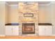 Cozy living room features a stone fireplace with custom cabinetry at 4763 Se 25Th Loop, Ocala, FL 34480