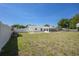 Large backyard with a white fence and enclosed lanai at 4810 County Road 114, Wildwood, FL 34785