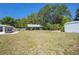 Large backyard with shed and carport for added storage and parking on a lush lawn at 4810 County Road 114, Wildwood, FL 34785