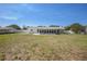 Backyard with a white privacy fence and a view of the home's enclosed lanai at 4810 County Road 114, Wildwood, FL 34785