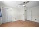 Bedroom with laminate flooring, a closet, and a door to an ensuite bathroom at 4810 County Road 114, Wildwood, FL 34785