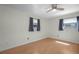 Bright bedroom featuring wood-look laminate flooring and a ceiling fan at 4810 County Road 114, Wildwood, FL 34785