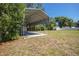 A sturdy metal carport sits on a grassy lot at 4810 County Road 114, Wildwood, FL 34785