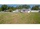 Single-story home with white fencing, a well-maintained lawn, and a side entry garage at 4810 County Road 114, Wildwood, FL 34785