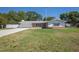 Charming single-story home with an attached garage, stone accents, and a well-manicured lawn at 4810 County Road 114, Wildwood, FL 34785